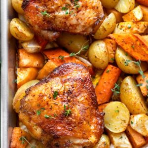 Crispy Roasted Thighs Over Roasted Vegetables
